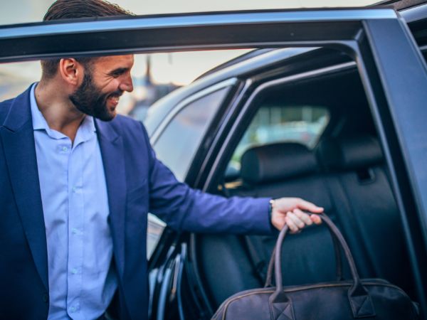 Man entering rental car Zambia