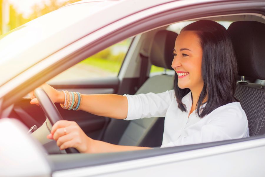 Happy Woman holding Car Rental Keys