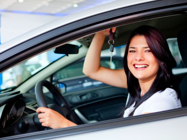 Happy Woman holding Car Rental Keys